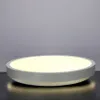 A round, white LED ceiling light with a gray rim is shown against a gray background. Náhľad obrázku produktu