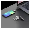 A dark gray surface with a laptop, a smartphone connected to the laptop via a cable, and a set of keys. Náhled obrázku produktu