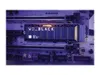 A close-up shot of a Western Digital Black SN850 NVMe SSD with a heatsink, installed on a motherboard. Podgląd zdjęcia produktu