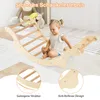 A young child is playing on a wooden climbing arch indoors, with stuffed animals in the background. Produktbild-Vorschau