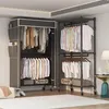 Two portable wardrobes with clothes hanging inside and some storage boxes at the bottom, set up in a room. Voir les images du produit