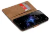 A brown book-style case for a smartphone, open to reveal the phone and two credit cards inside. Náhľad obrázku produktu