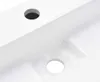 A close-up view of a white sink with two circular holes drilled into it. Náhľad obrázku produktu
