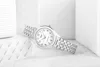 A silver Casio watch is displayed on a textured white surface, with abstract white shapes in the background. Anteprima dell’immagine prodotto