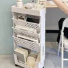 A mobile storage cart filled with books and office supplies next to a desk. Produktbild-Vorschau