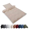 A beige duvet cover and pillow set is displayed diagonally on a white background, with a row of different colored duvet cover sets shown below. Produktbild-Vorschau