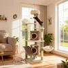 A multi-level cat tree with two cats interacting with it in a living room setting. Produktbild-Vorschau