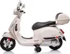 A white electric Vespa scooter for children is shown against a white background. Voir les images du produit
