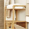 A bamboo laundry basket with shelves, filled with folded towels. Podgląd zdjęcia produktu