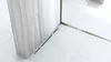 A close-up view of a modern shower drain with a gold finish, set against white tiled flooring and a marble-effect wall. Náhľad obrázku produktu