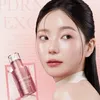A close-up marketing image of a woman with a skincare product. Produktbild-Vorschau