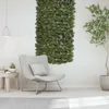 A modern living room with a chair and a decorative green leaf panel on the wall. Anteprima dell’immagine prodotto