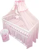 A baby crib with bedding and a canopy, set against a white background. Produktbild-Vorschau