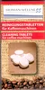 A close-up of a product package for cleaning tablets for coffee machines, with coffee beans in the foreground. Produktbild-Vorschau