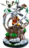 A statue of Aang from Avatar: The Last Airbender, with Momo flying above him, surrounded by swirling air and green leaves, on a rocky base with clouds at the bottom. Náhled obrázku produktu