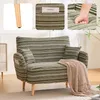 A collage of images showing a green striped armchair, its wooden leg, a close-up of its side pocket with a book, and a hand pressing into its cushion. Anteprima dell’immagine prodotto