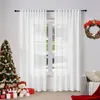 A festive Christmas scene with a decorated tree, gifts, and a wreath next to white sheer curtains. Produktbild-Vorschau