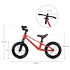 A red balance bike with dimensions indicated by measurement lines and text. Náhled obrázku produktu