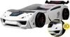 A white race car-shaped children's bed with a spoiler, displayed on a white background. A close-up inset shows the headlights. Produktbild-Vorschau
