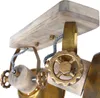 Close-up view of a steampunk-style light fixture, focusing on the wooden and brass components and decorative gears. Produktbild-Vorschau