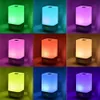 A collage of nine images, each showing a bedside lamp with a digital clock display, illuminated in different colors. Podgląd zdjęcia produktu
