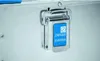 Close-up of a metal transport box latch with a blue label. Produktbild-Vorschau