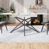 A dining table set with chairs in a well-lit room with a fireplace. Produktbild-Vorschau
