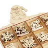 A close-up view of wooden Christmas ornaments in a divided box, with a Santa Claus cutout at the top. Produktbild-Vorschau