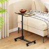 A portable table with wheels next to a sofa. Podgląd zdjęcia produktu