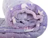 A close-up of a rolled-up fluffy blanket with a star pattern. Anteprima dell’immagine prodotto