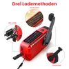 A red emergency radio with solar panels and a hand crank, shown with callouts explaining its charging methods. Produktbild-Vorschau