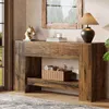 A wooden console table with decorative items and a lamp, placed in a room near a window. Produktbild-Vorschau