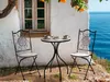 A bistro set on a terrace overlooking the sea. Náhled obrázku produktu