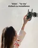 A person is installing a security camera on a wall. Produktbild-Vorschau