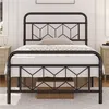 A black metal bed frame with a geometric headboard and footboard, set up in a bedroom with nightstands on either side. Produktbild-Vorschau