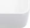 A close-up view of the corner of a white ceramic sink. Náhľad obrázku produktu