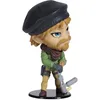 A figurine of a character wearing a beret, green jacket, and holding a tool. Produktbild-Vorschau