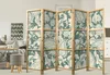 A room divider is shown in a living room setting, with furniture and decor visible in the background. Náhled obrázku produktu