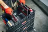 A person wearing orange gloves is organizing tools in a stackable toolbox. Náhled obrázku produktu