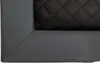 A close-up view of a corner of a dog bed, showing the quilted black fabric and the gray faux leather trim. Anteprima dell’immagine prodotto