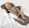 A baby is sitting in a high chair. Voir les images du produit