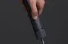 A hand is holding a dark blue electric screwdriver. Podgląd zdjęcia produktu