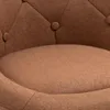 A close-up view of a tufted brown armchair seat and the lower backrest. Produktbild-Vorschau