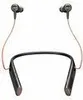 A pair of black neckband earphones with pink wires against a white background. Voir les images du produit