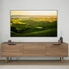A modern living room with a TV mounted on the wall above a wooden media console. Produktbild-Vorschau