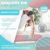 A woman is performing a handstand on a pink yoga mat in a bright room, with a gray exercise ball in the background. Text overlays highlight product features. Produktbild-Vorschau