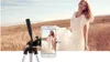 A woman in a white dress is posing in a field, with a smartphone on a tripod in the foreground showing a preview of the photo being taken. Anteprima dell’immagine prodotto