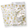 Two clear plastic bags with gold star patterns are shown against a white background. One bag is slightly in front of the other, and the one in the back has a label with product information. Produktbild-Vorschau