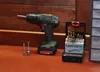 A cordless drill with accessories on a wooden surface. Produktbild-Vorschau