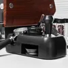 A close-up shot of a black espresso tamping station with a wooden accent. Náhled obrázku produktu